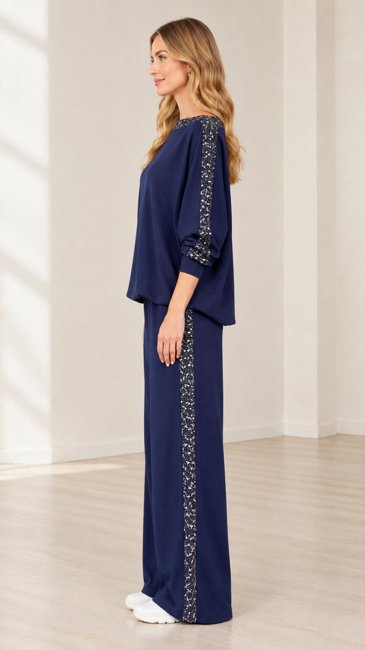 Side profile view of navy blue sequin trim matching lounge set with wide leg pants