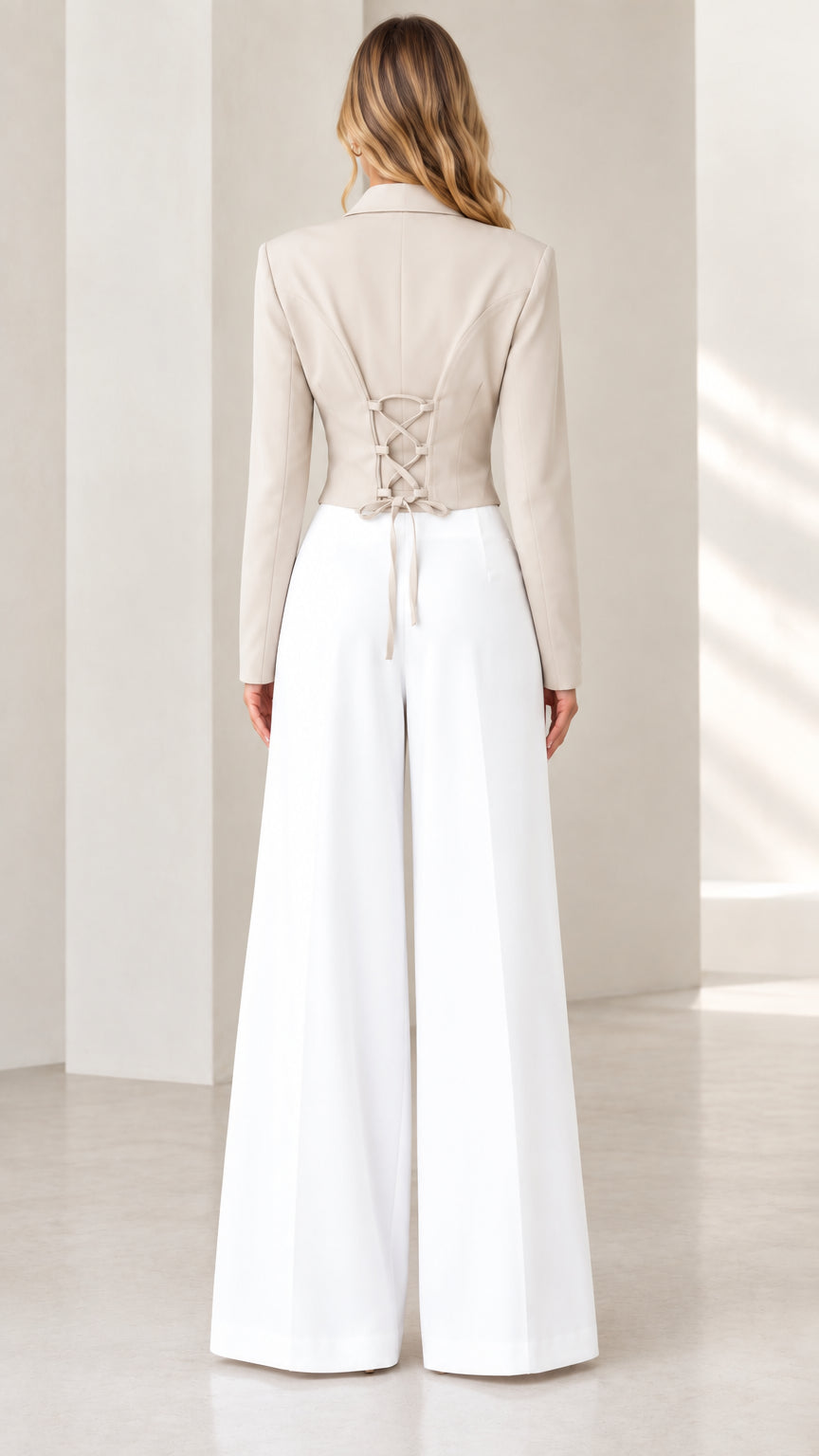 Back view of beige corset blazer showing the adjustable lace-up tie detail