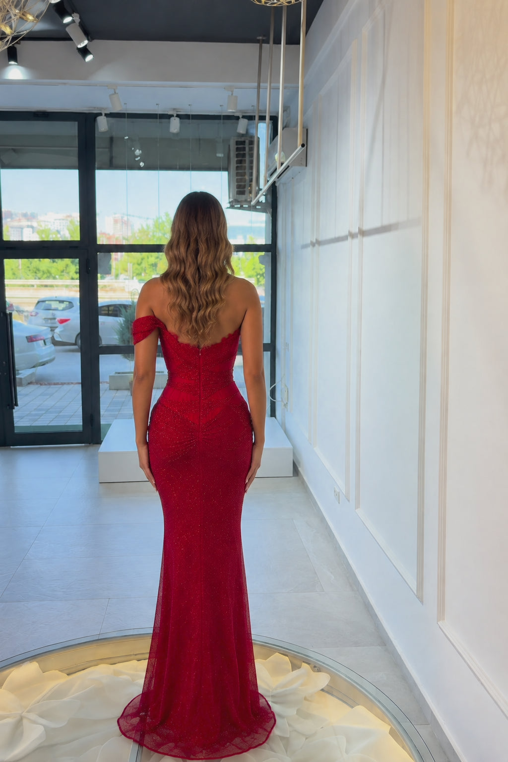Back view of woman wearing fitted red formal mermaid dress