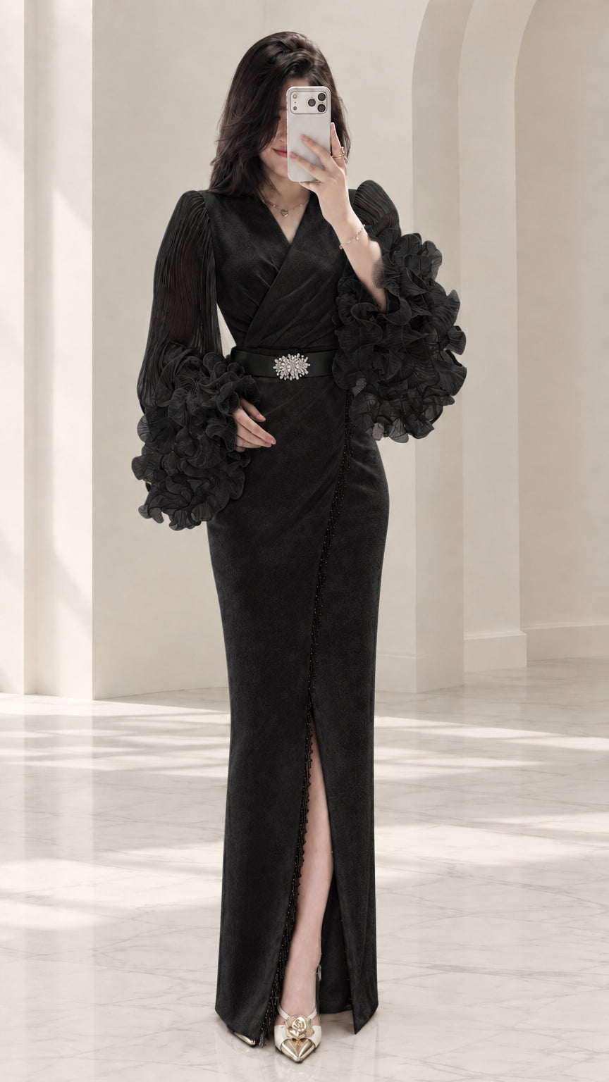Black long sleeve formal evening gown with voluminous ruffle sleeves and crystal belt