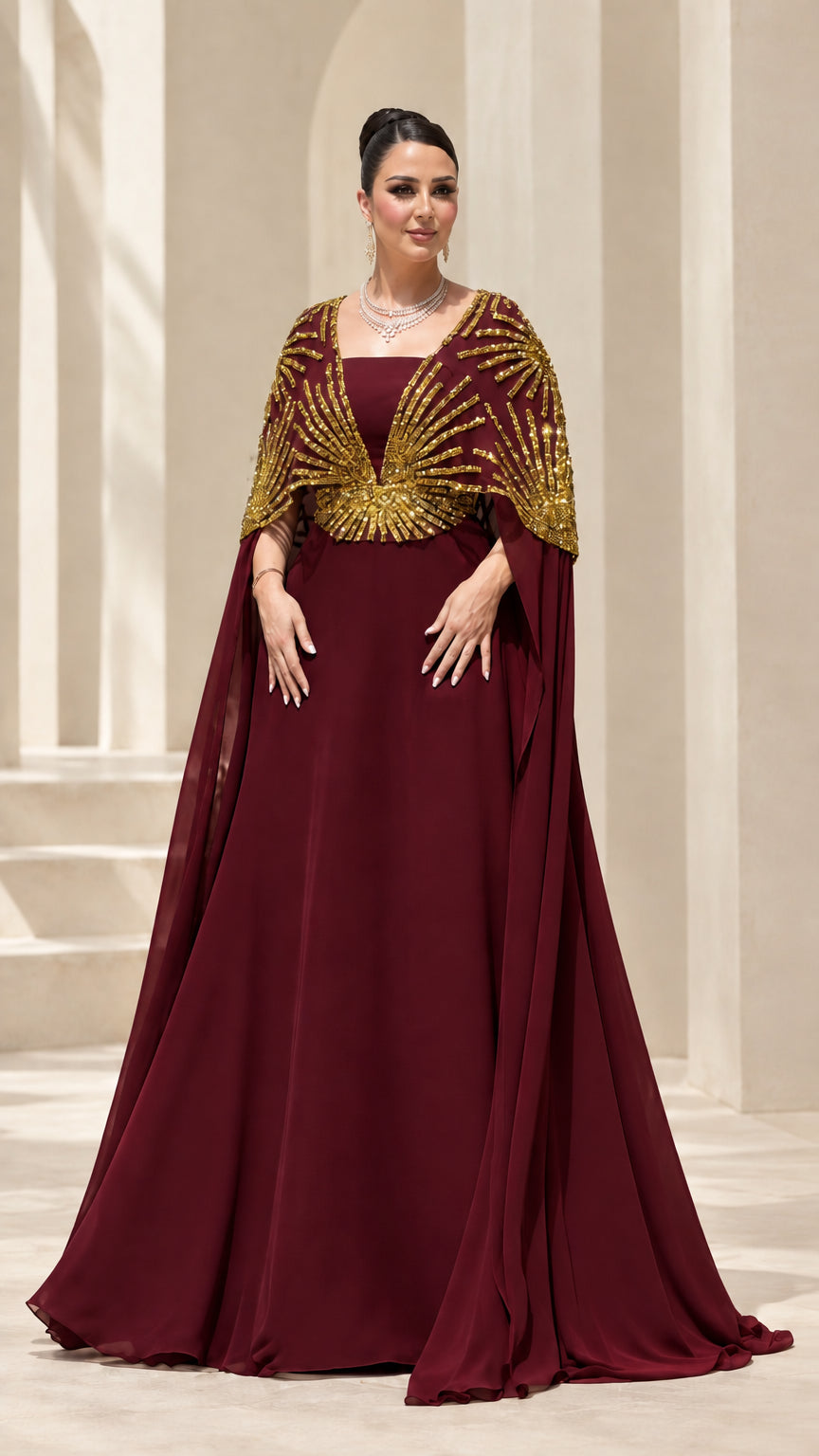 Burgundy red formal evening gown with gold sunburst capelet