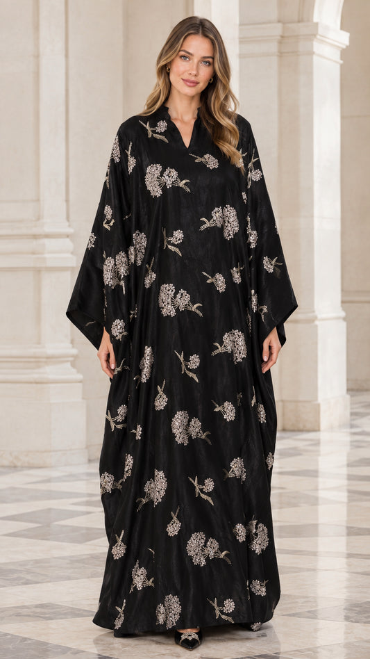 Front view of woman wearing black floral embroidered kaftan maxi dress with wide sleeves