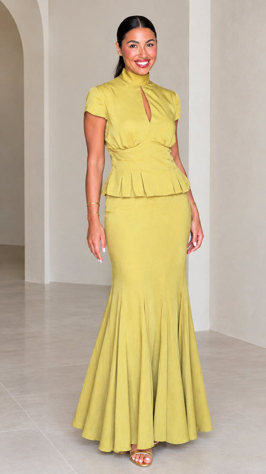 Front full-length view of woman wearing Chartreuse high neck peplum mermaid maxi dress set