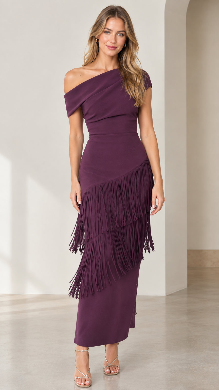 Front full-length view of woman wearing plum one-shoulder tiered fringe midi dress