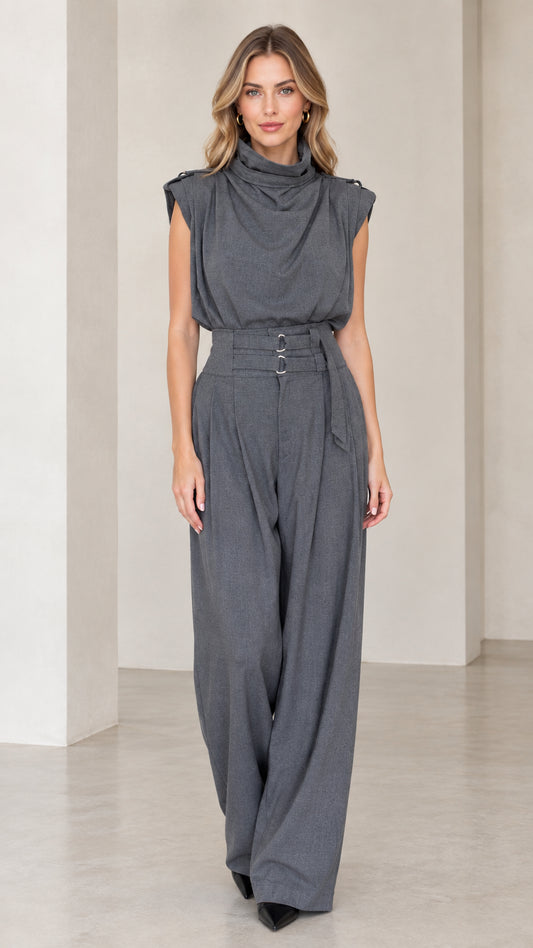 Front view of woman wearing a charcoal grey sleeveless drape high neck wide leg jumpsuit with belt