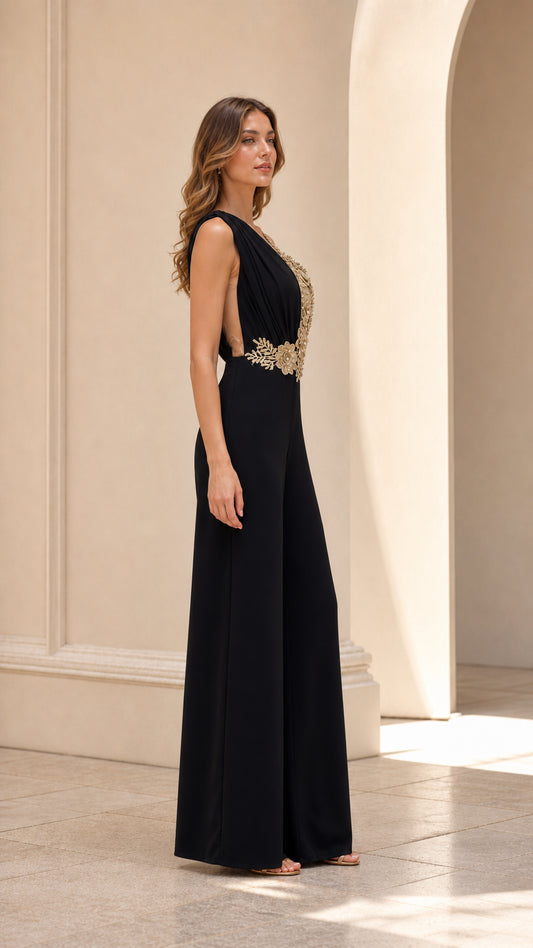 Side profile of model in black formal palazzo jumpsuit with gold floral embroidery