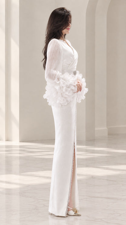 Side profile of white floor-length evening dress showing front slit detail