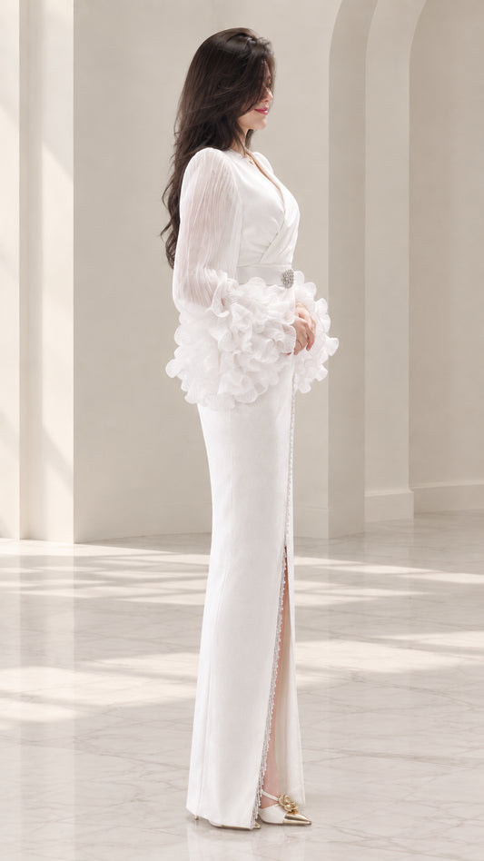 Side profile of white floor-length evening dress showing front slit detail