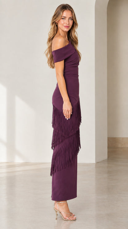 Side full-length view of woman in plum one-shoulder fringe evening dress