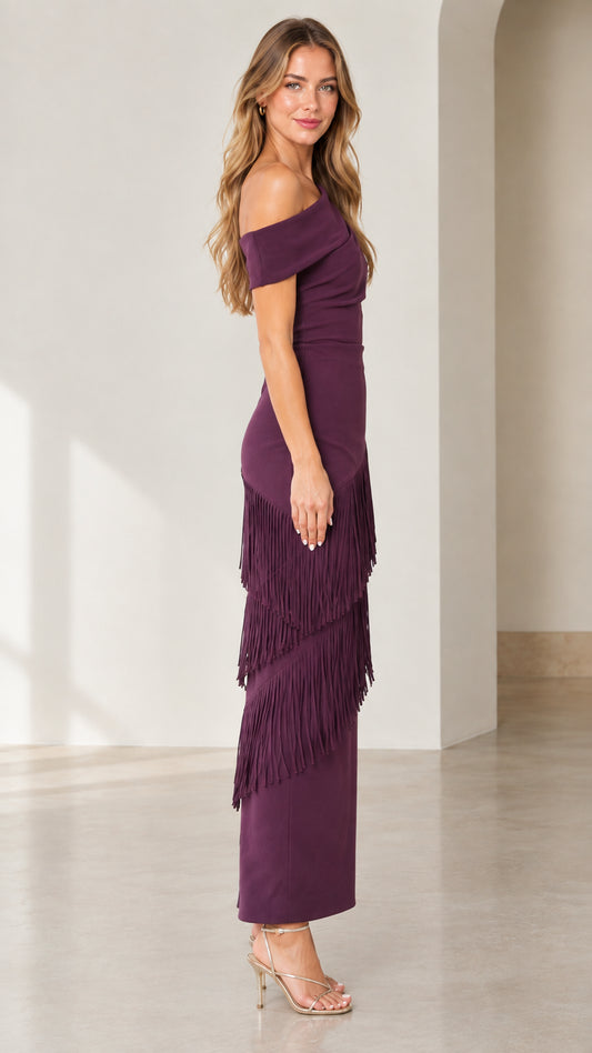 Side full-length view of woman in plum one-shoulder fringe evening dress