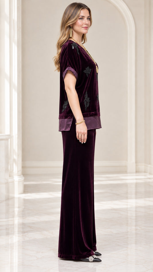 Side profile view of model in Plum velvet two-piece top and matching pants