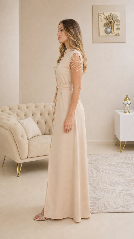Side profile view of elegant beige floor-length evening dress with waist tie belt