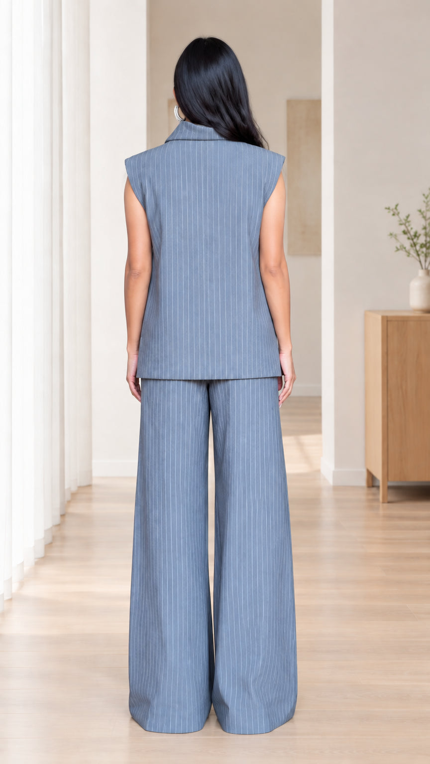 Back view of women's slate blue sleeveless top and wide-leg trousers set