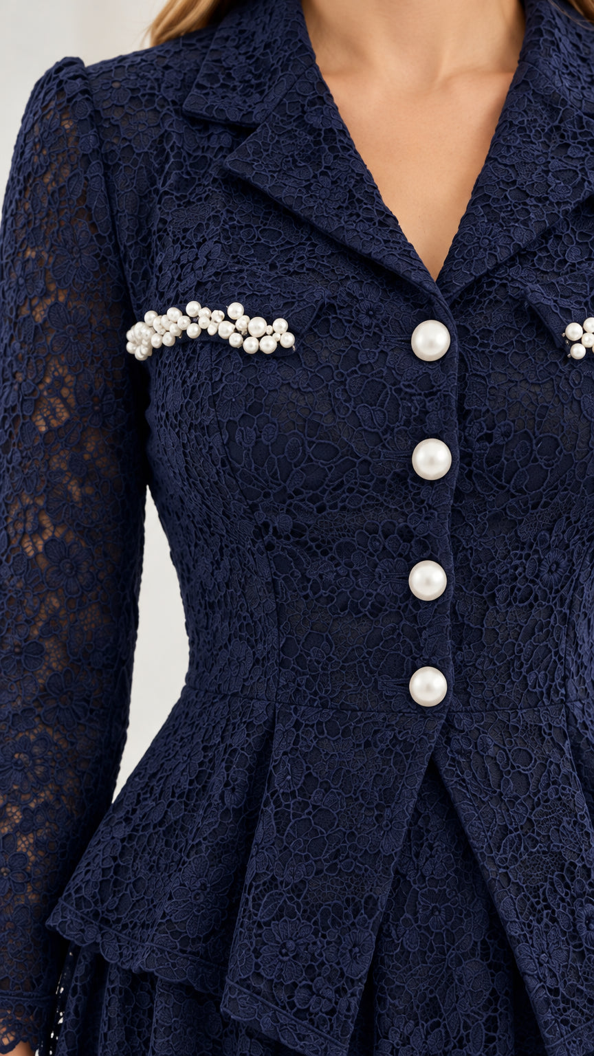 Close-up detail of notch lapel, pearl trim, and lace texture in navy blue