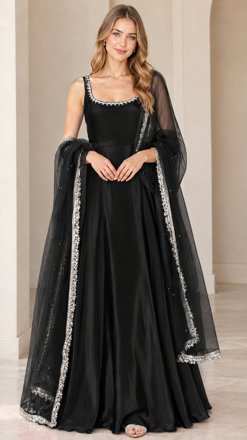 Front view of model wearing black flared sleeveless gown with matching black embellished dupatta