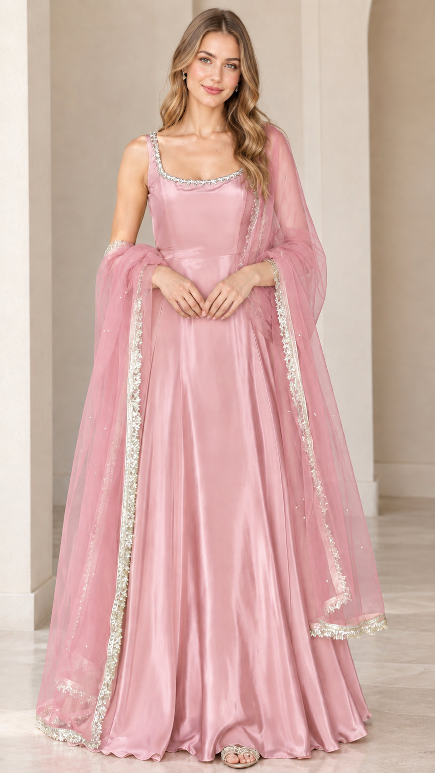 Front view of model wearing dusty pink sleeveless flared maxi gown with matching sheer dupatta