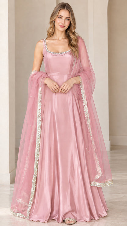 Front view of model wearing dusty pink sleeveless flared maxi gown with matching sheer dupatta
